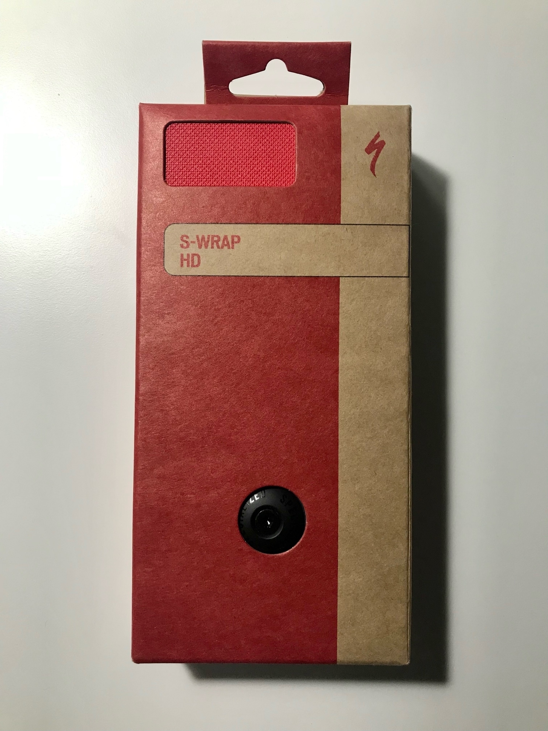 Drop bar handle bar tape rolls in red and brown cardboard packaging.